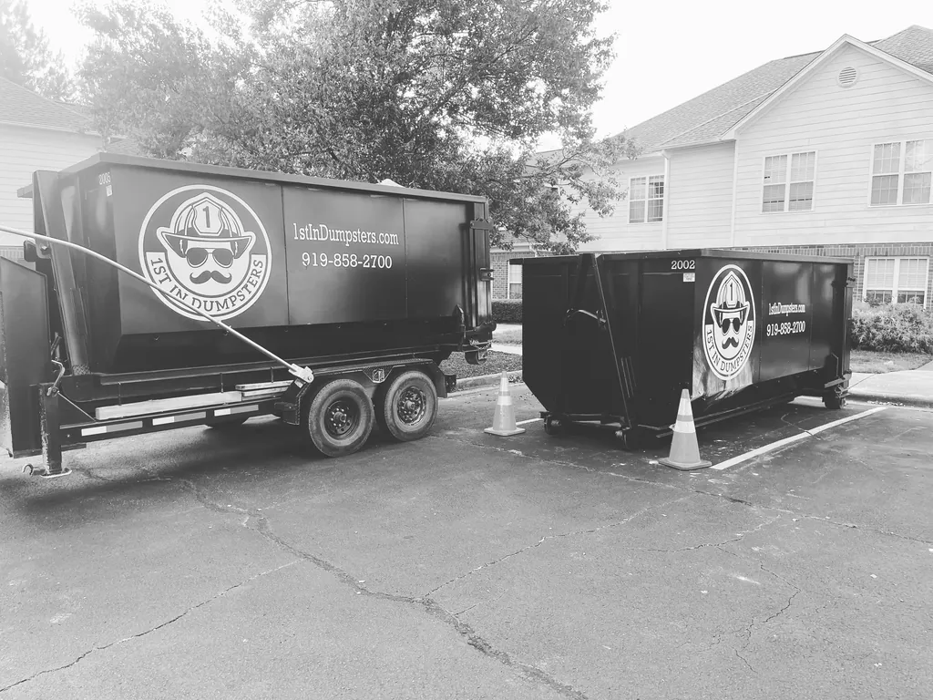 1st In Dumpsters dumpster trailer and roll off dumpster in an apartment parking lot