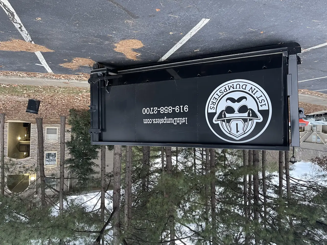 1st In Dumpsters roll off dumpster in an apartment complex parking lot